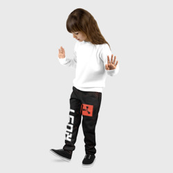 Брюки с принтом Rust - Гранж для ребенка, вид на модели спереди №2. Цвет основы: черный