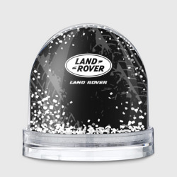 Игрушка Снежный шар Land Rover Speed на темном фоне со следами шин