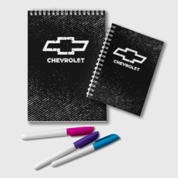 Блокнот Chevrolet с потертостями на темном фоне